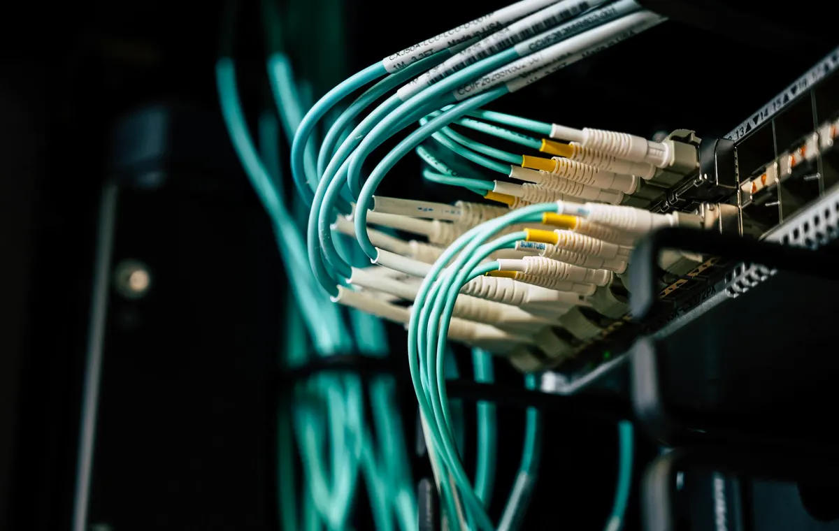 Fiber-optic network cables connected in a server rack