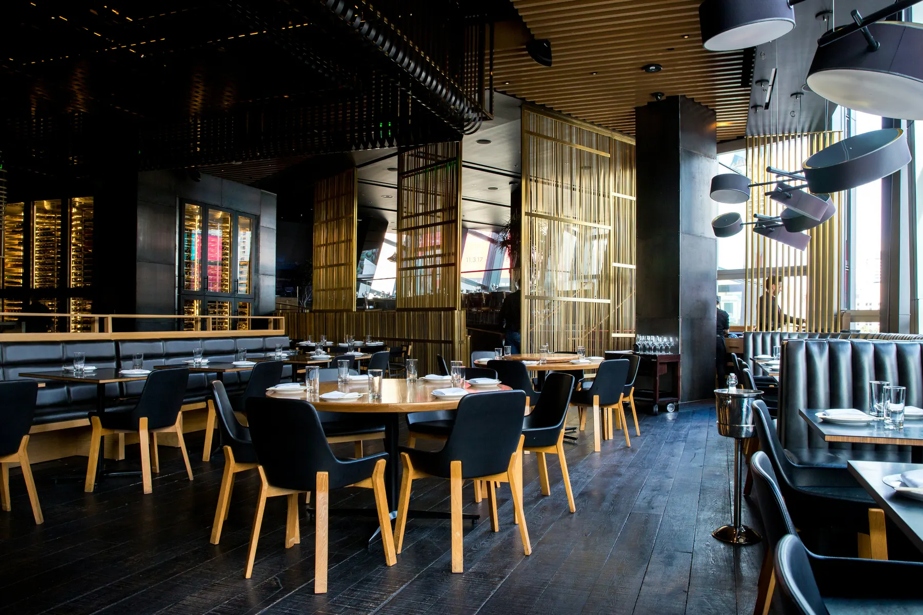 Modern restaurant dining room with tables and booth seating